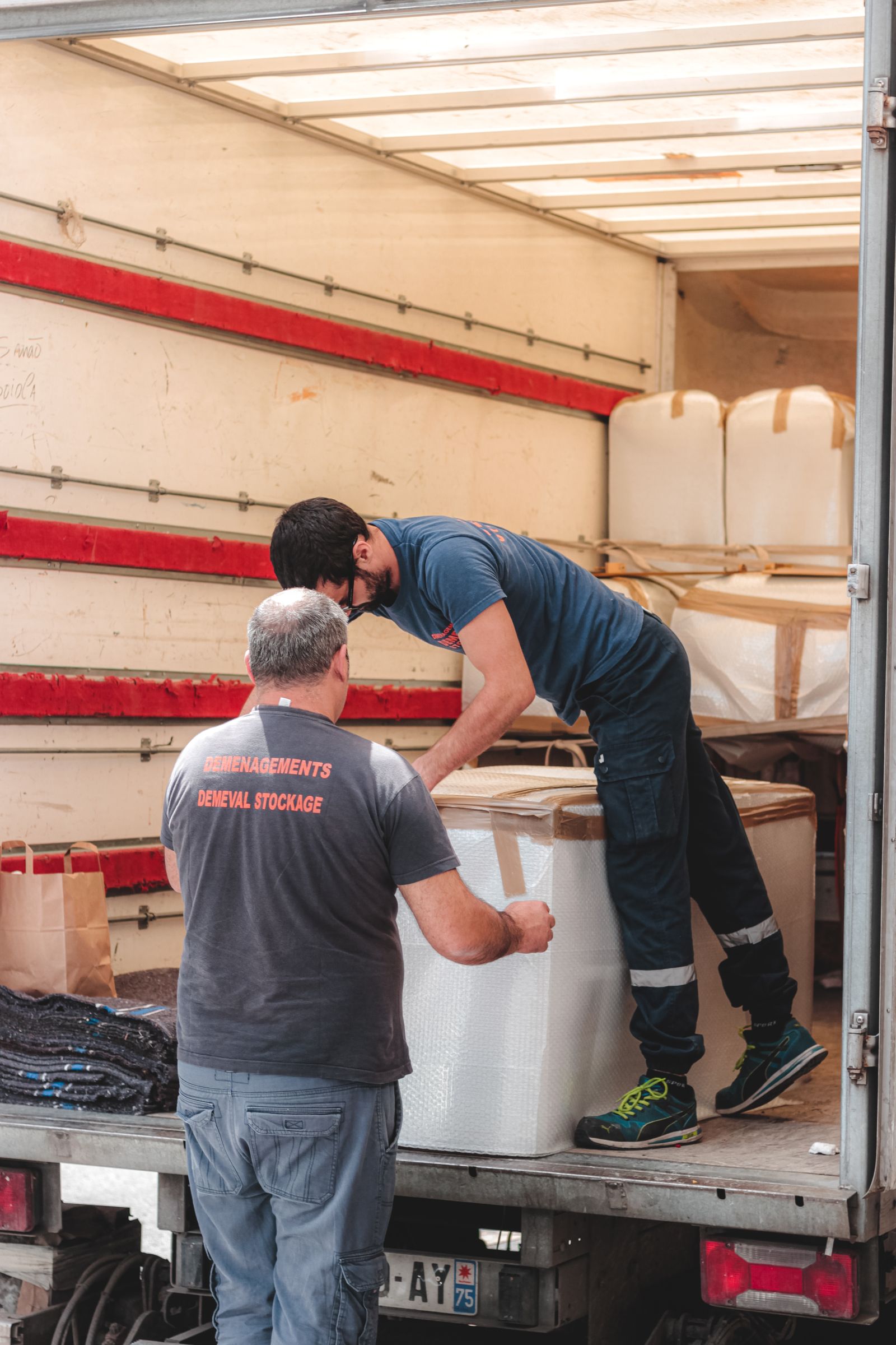 Junk removal crew loading a full truck in Fresno